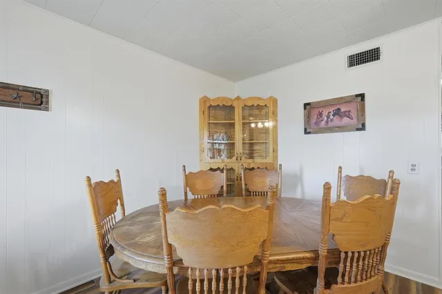 a dining room with furniture and wooden floor