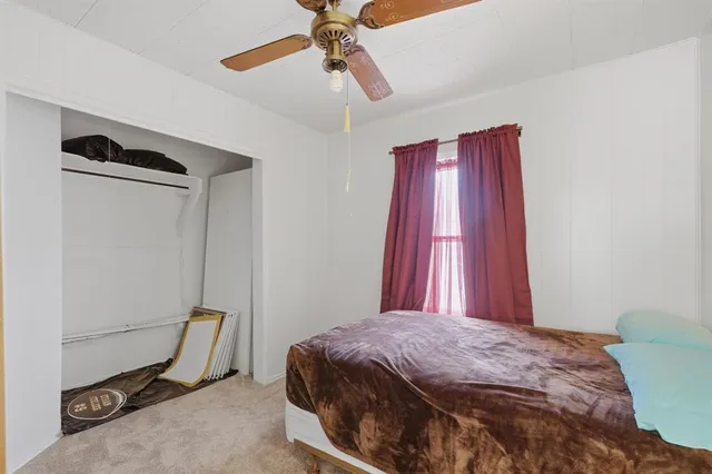 a bed sitting in a bedroom next to a window