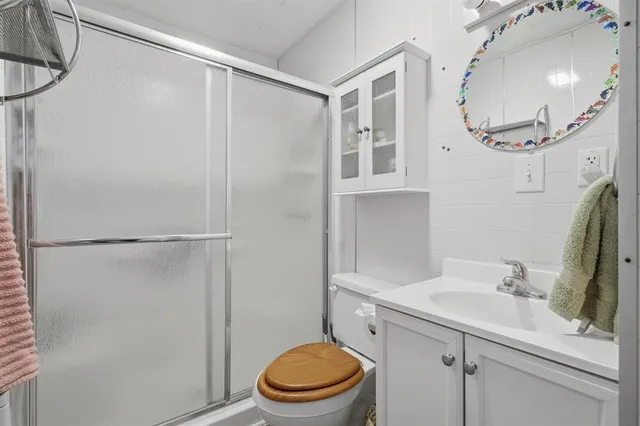 a bathroom with a sink a toilet and a mirror