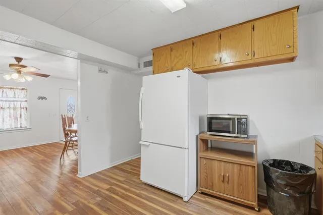 a kitchen with stainless steel appliances a refrigerator and a stove top oven