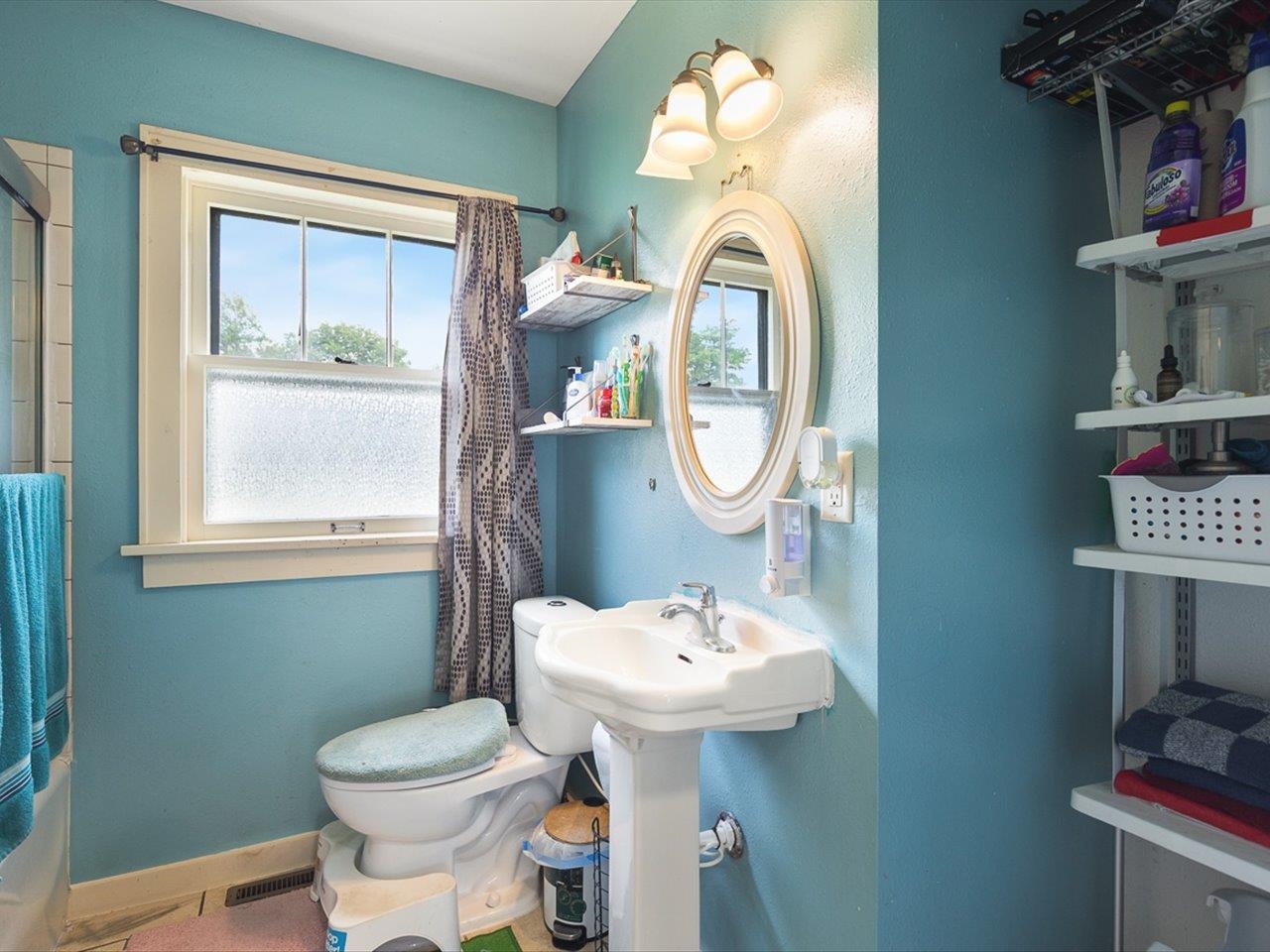 1247 West Logan Street Freeport, IL 61032 - Photo 15 of 34 a bathroom with a toilet sink and mirror