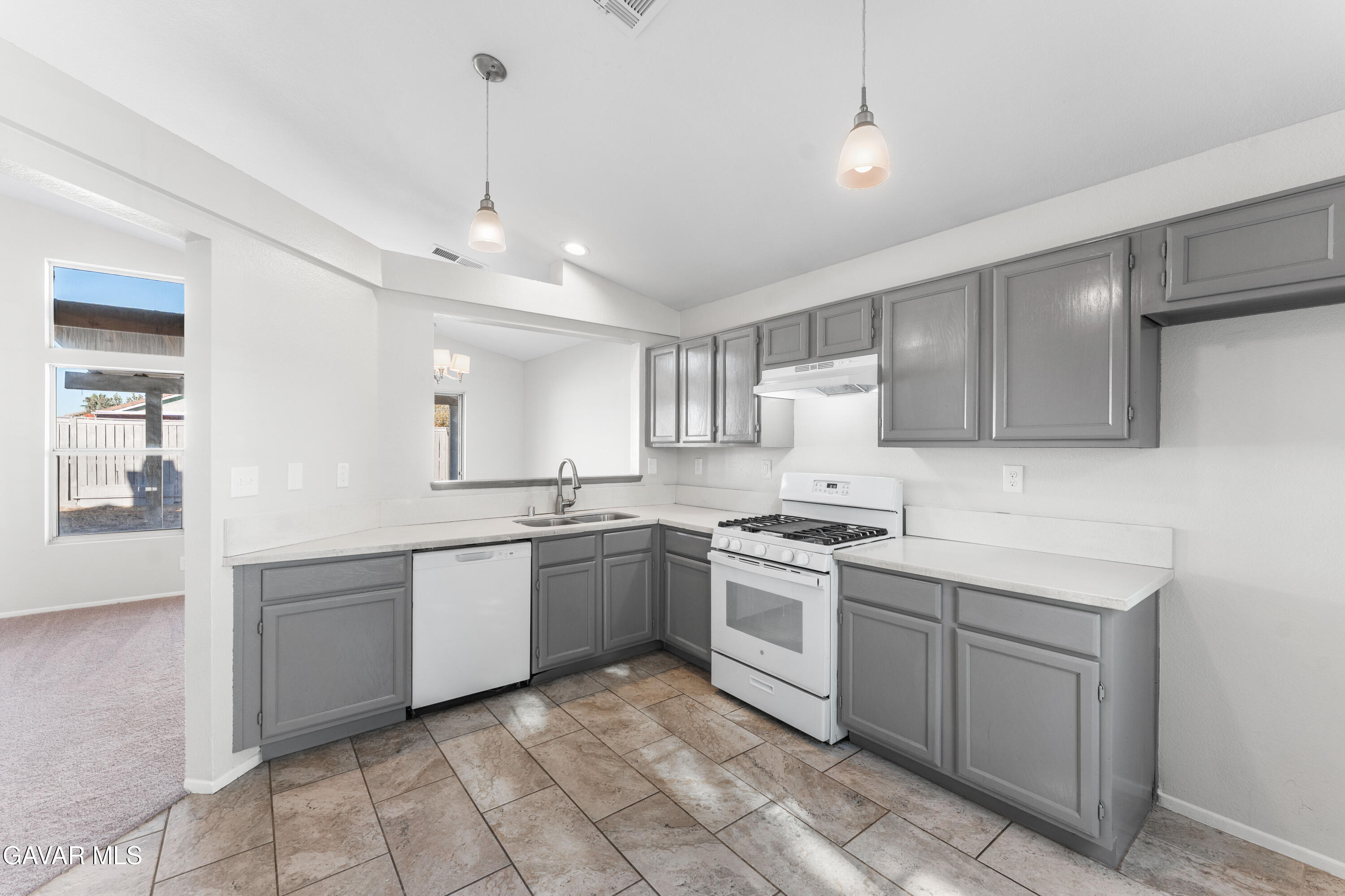 37031 Firethorn Street Palmdale, CA 93550 - Photo 16 of 36 a kitchen with white cabinets appliances and a sink