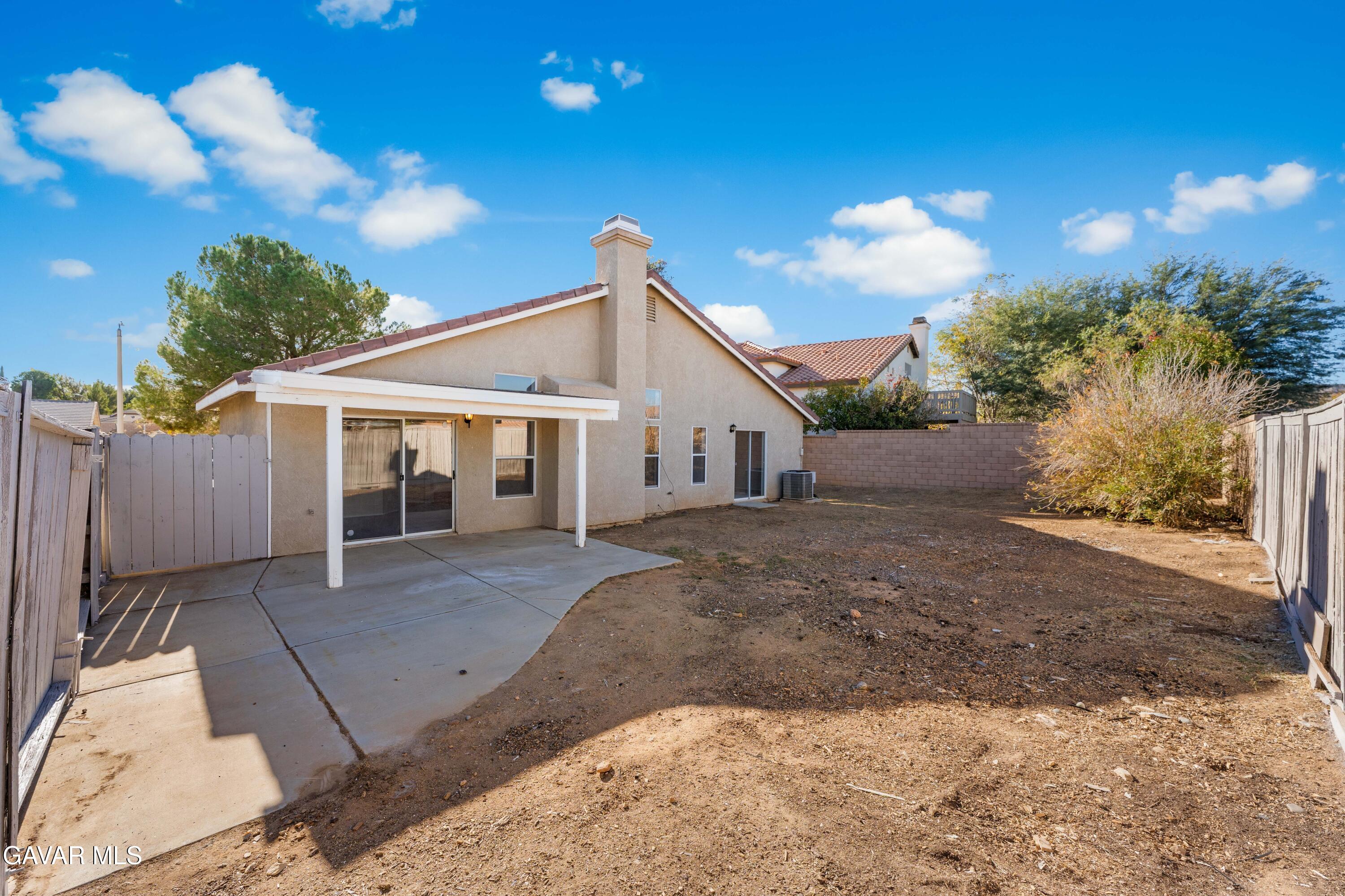 37031 Firethorn Street Palmdale, CA 93550 - Photo 28 of 36 a view of a house with backyard and a tree