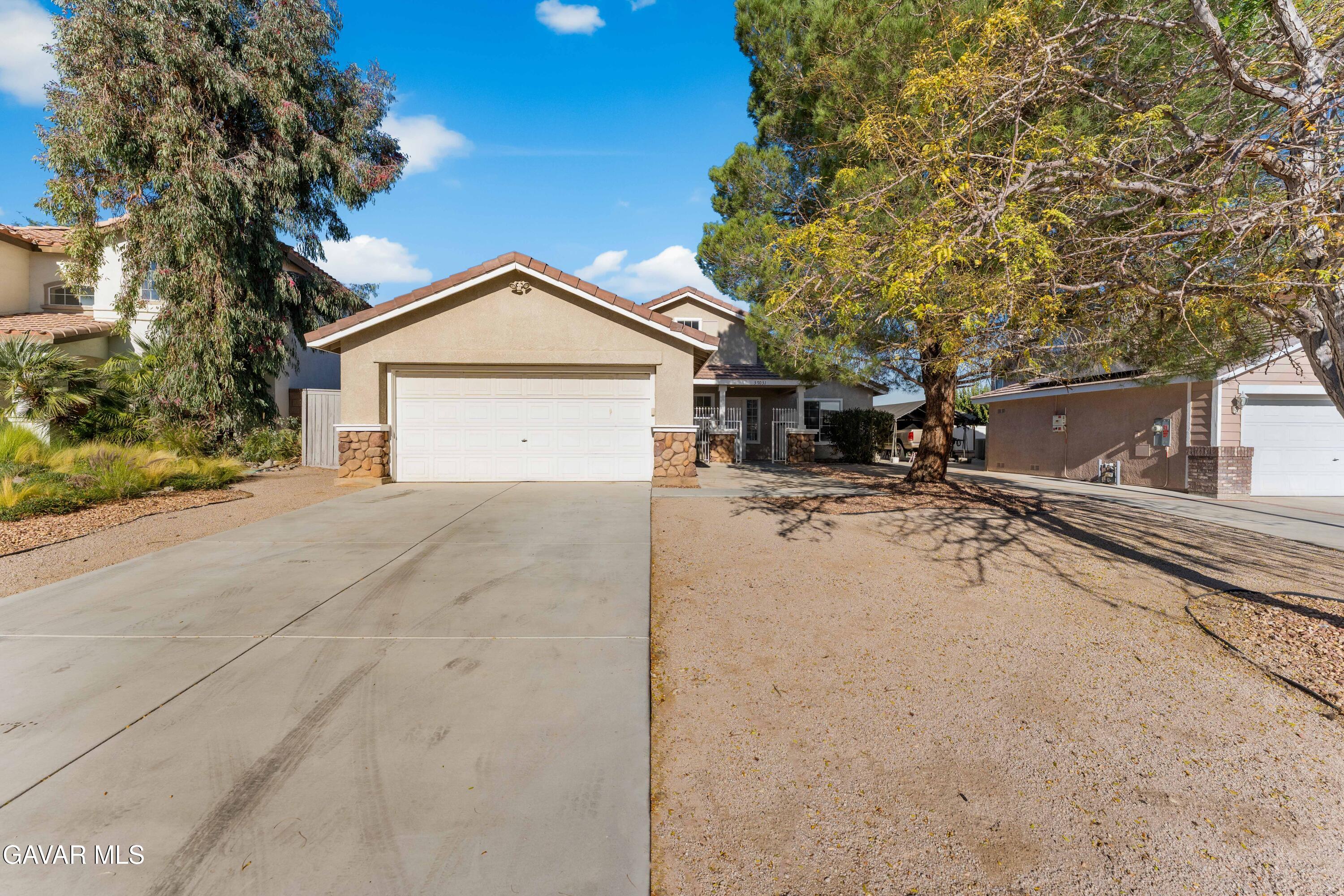 37031 Firethorn Street Palmdale, CA 93550 - Photo 3 of 36 a view of a house with a yard covered in snow