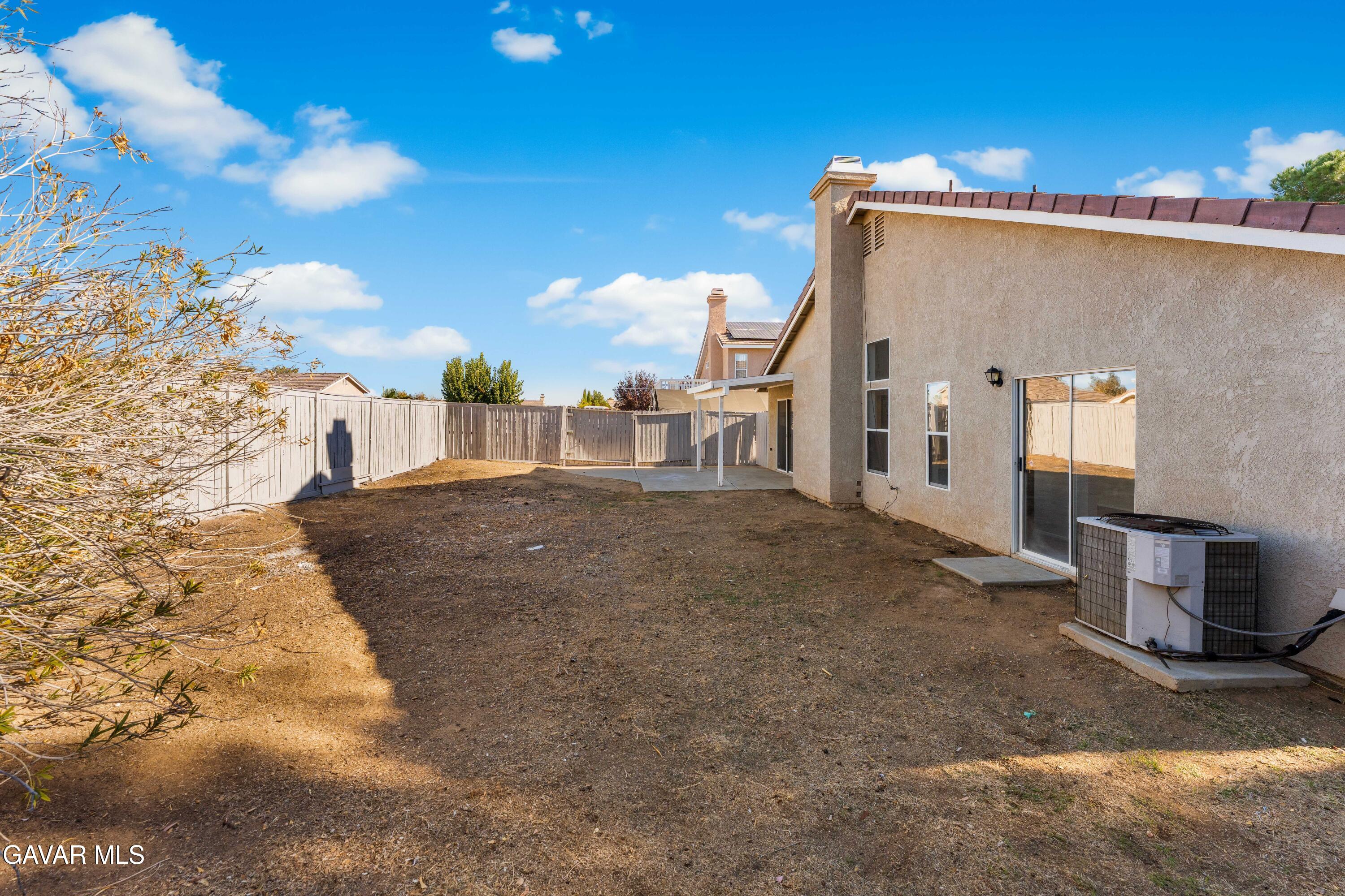 37031 Firethorn Street Palmdale, CA 93550 - Photo 32 of 36 a view of a street with a building in the background