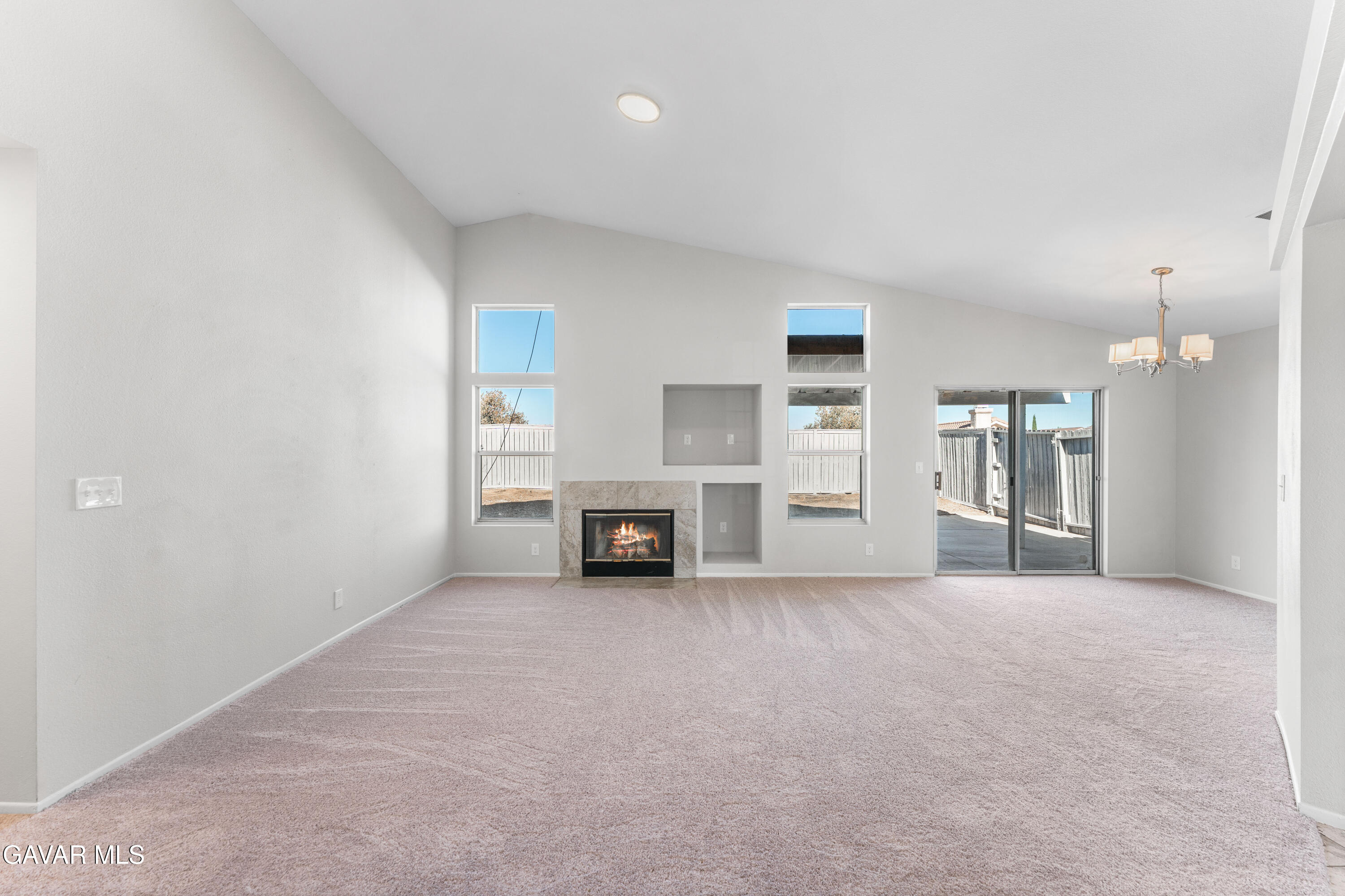 37031 Firethorn Street Palmdale, CA 93550 - Photo 7 of 36 an empty room with furniture and a kitchen