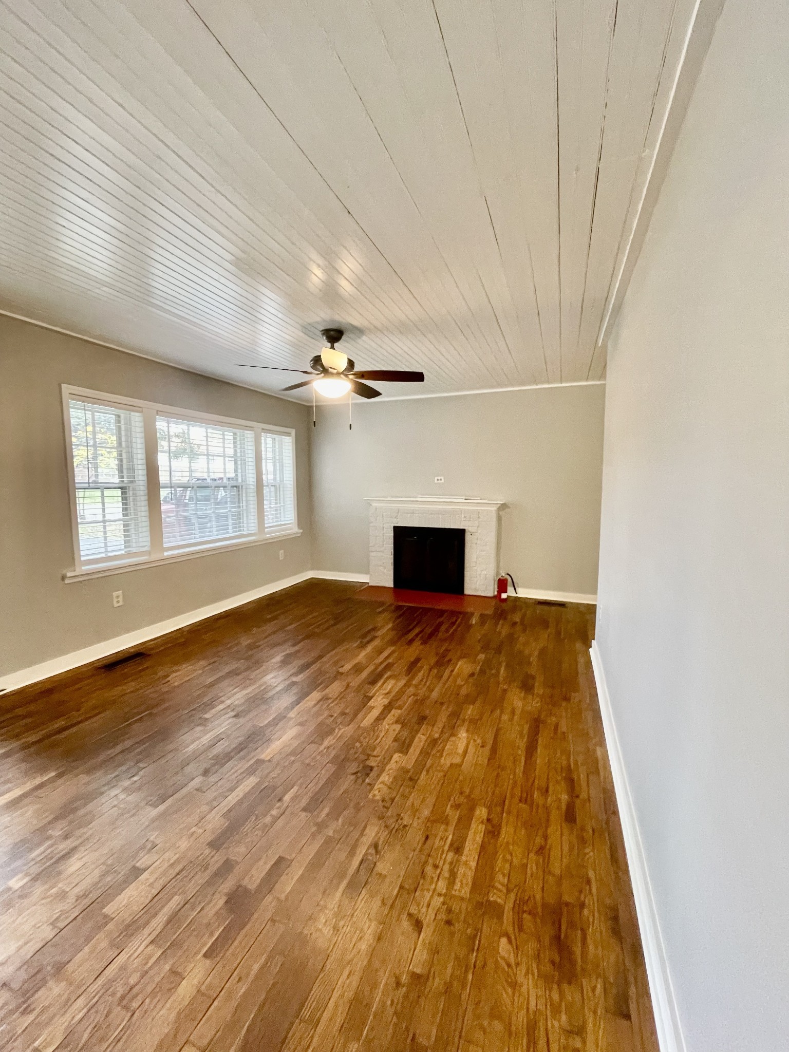 209 Frank Street Lawrenceburg, TN 38464 - Photo 11 of 34 a big room with wooden floor and windows