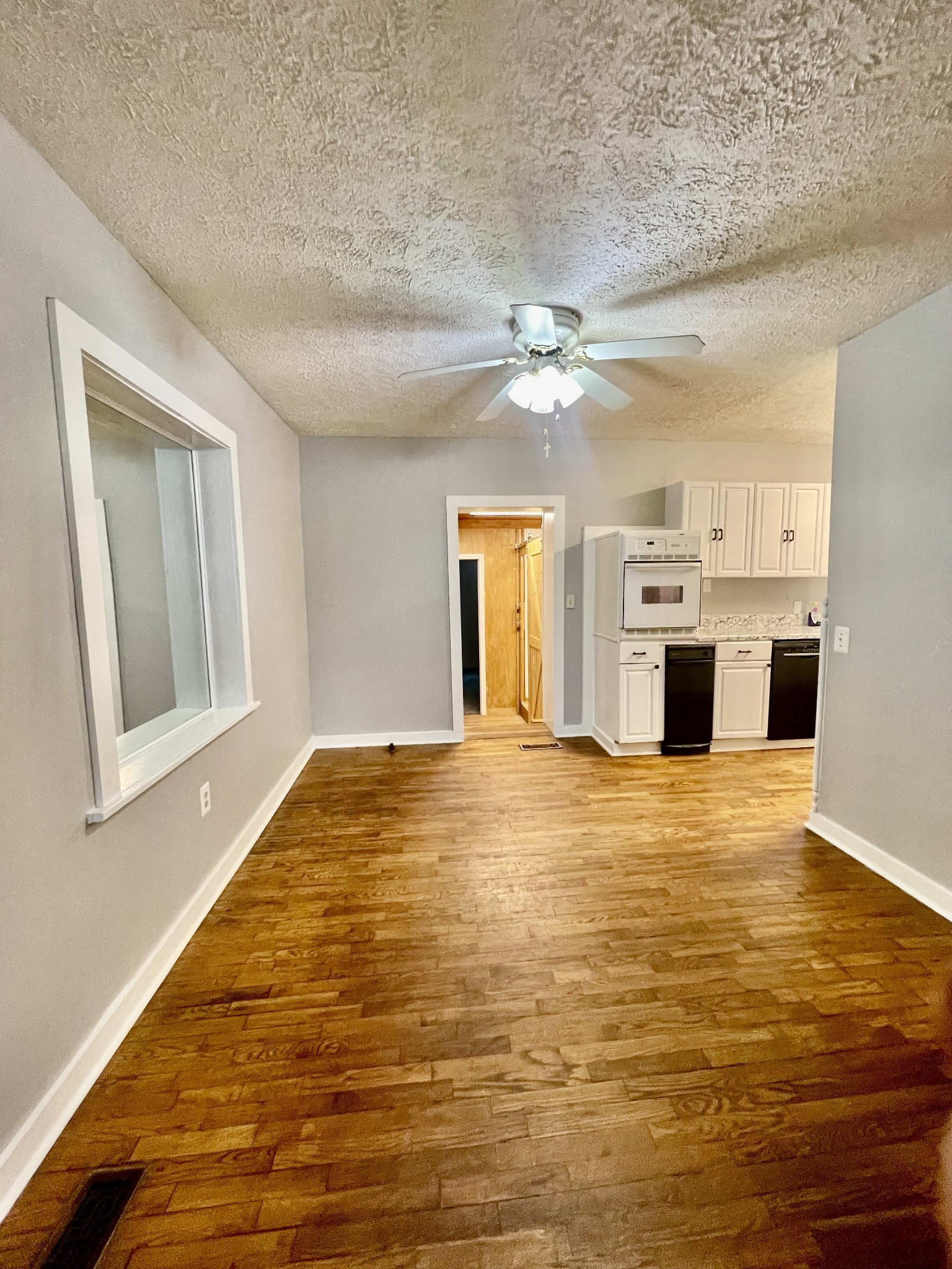 209 Frank Street Lawrenceburg, TN 38464 - Photo 13 of 34 a view of an empty room with kitchen and a window
