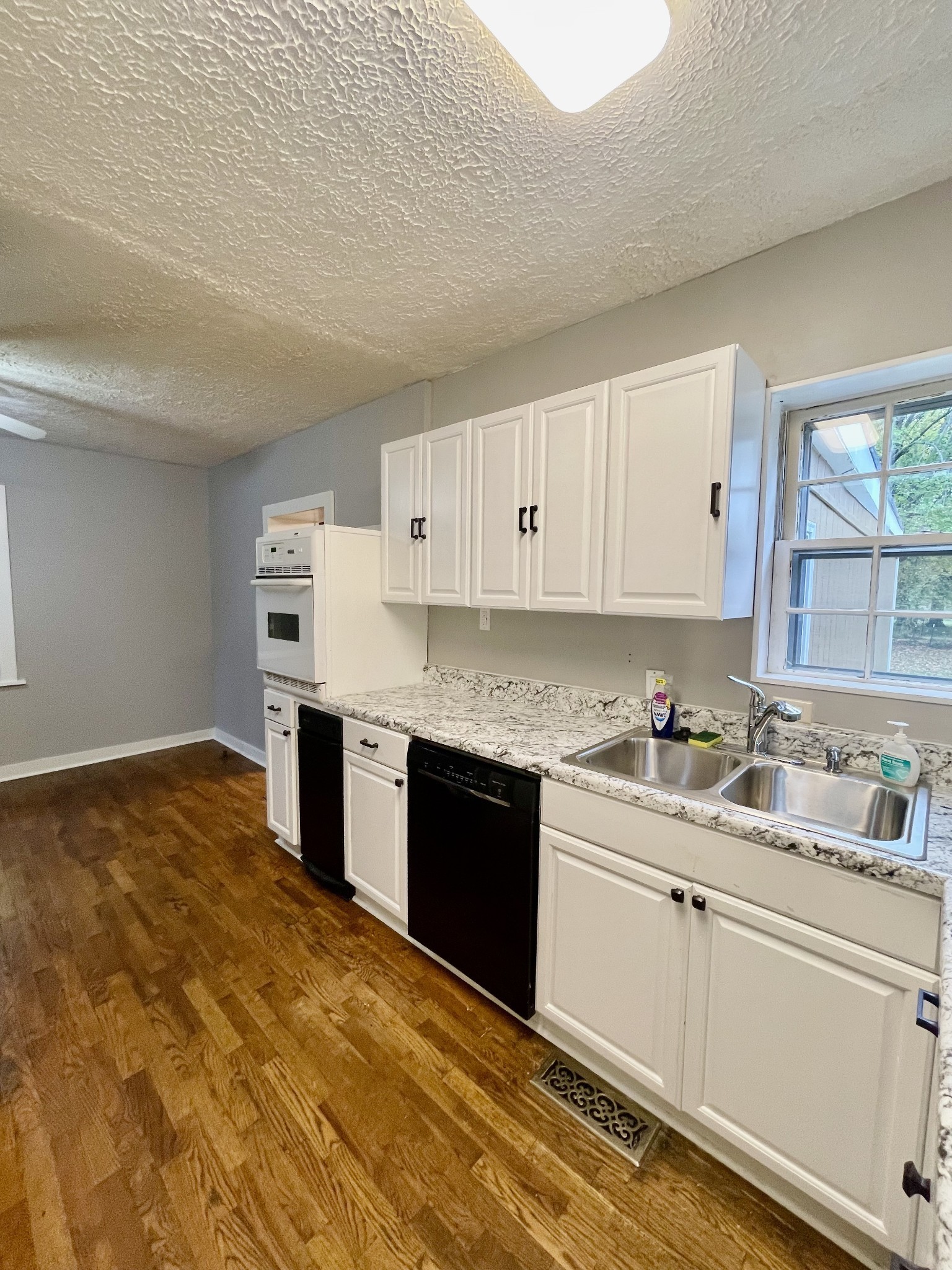 209 Frank Street Lawrenceburg, TN 38464 - Photo 17 of 34 a kitchen with a sink stove and cabinets