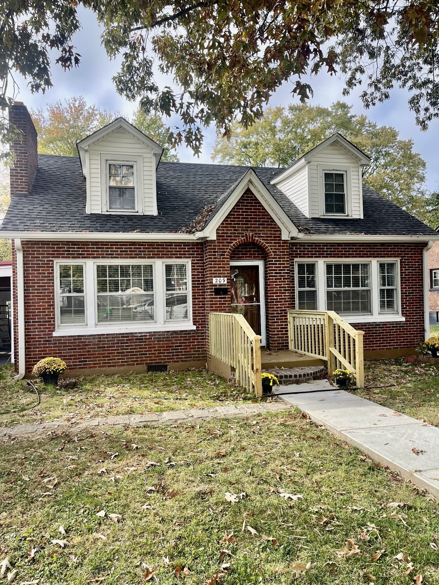 209 Frank Street Lawrenceburg, TN 38464 - Photo 3 of 34 a front view of a house with a yard
