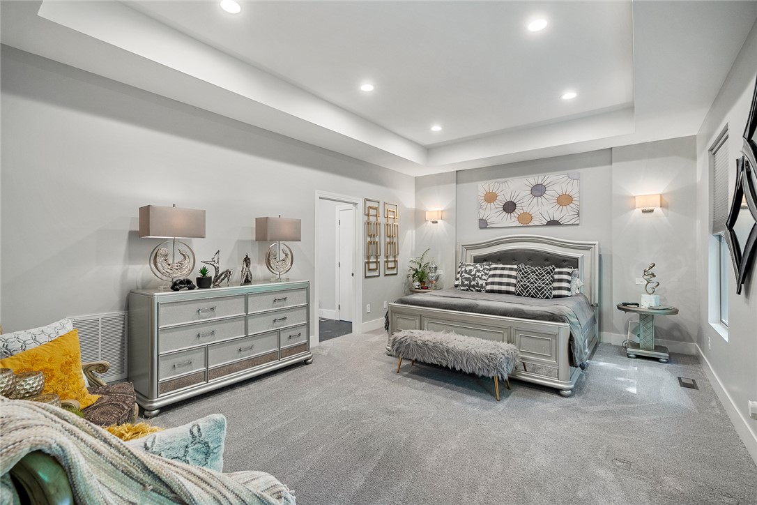 140 Turnberry Road Anderson, SC 29621 - Photo 16 of 44 This primary bedroom features plush carpeting and elegant recessed lighting, creating a serene and inviting atmosphere.