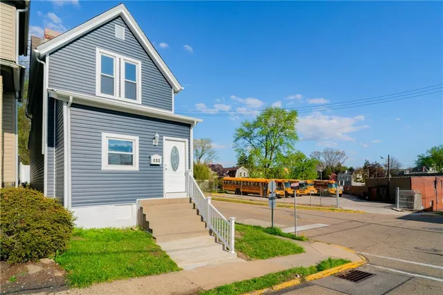 a front view of a house with a garden