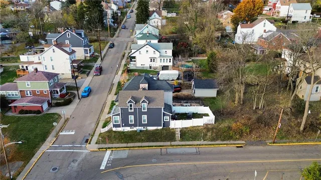 an aerial view of multiple houses with a street