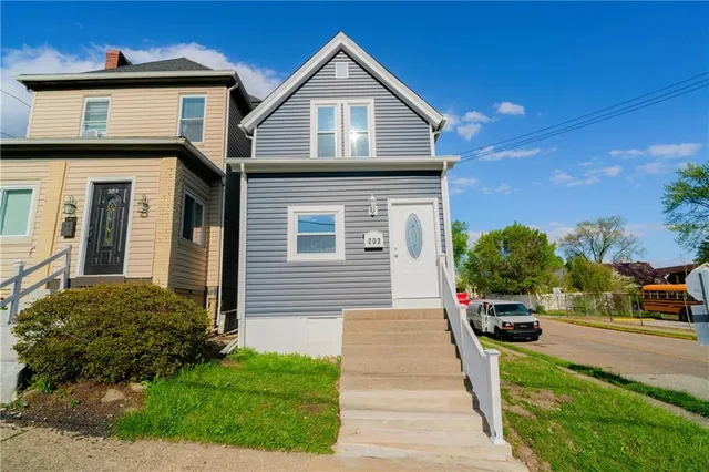 a front view of a house with a yard
