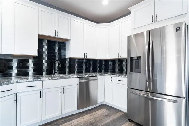 a kitchen with stainless steel appliances a refrigerator and cabinets