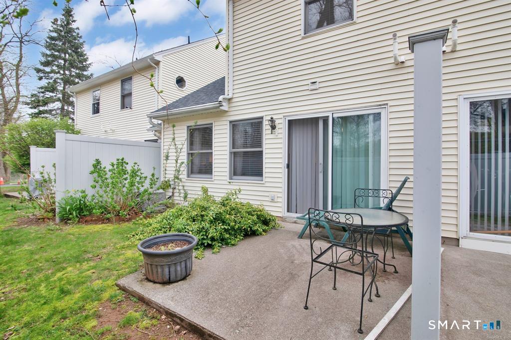 16 Maple Street, Unit 3 Vernon, CT 06066 - Photo 13 of 13 a view of a patio with chair and table and chairs and potted plants