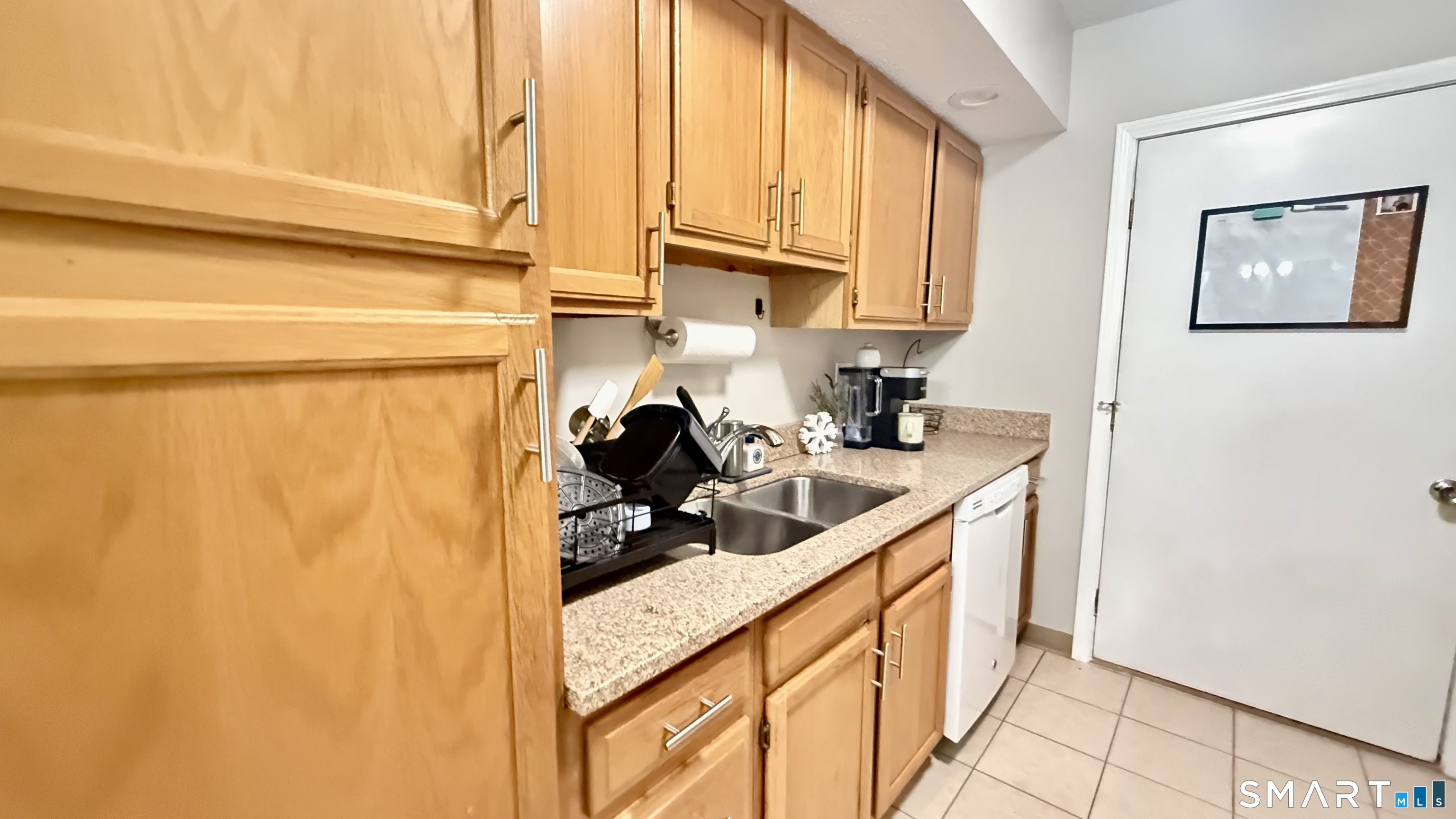 16 Maple Street, Unit 3 Vernon, CT 06066 - Photo 5 of 13 a kitchen with stainless steel appliances a sink a refrigerator and cabinets