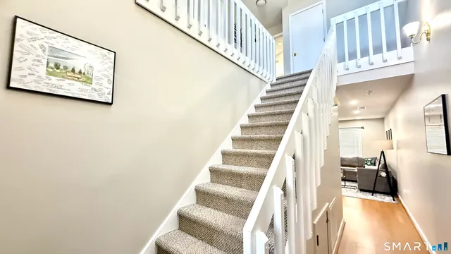 a view of entryway and hall with wooden floor