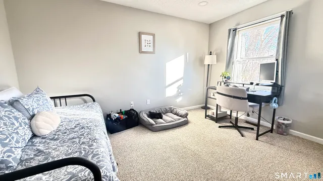 a bedroom with a bed and a chair