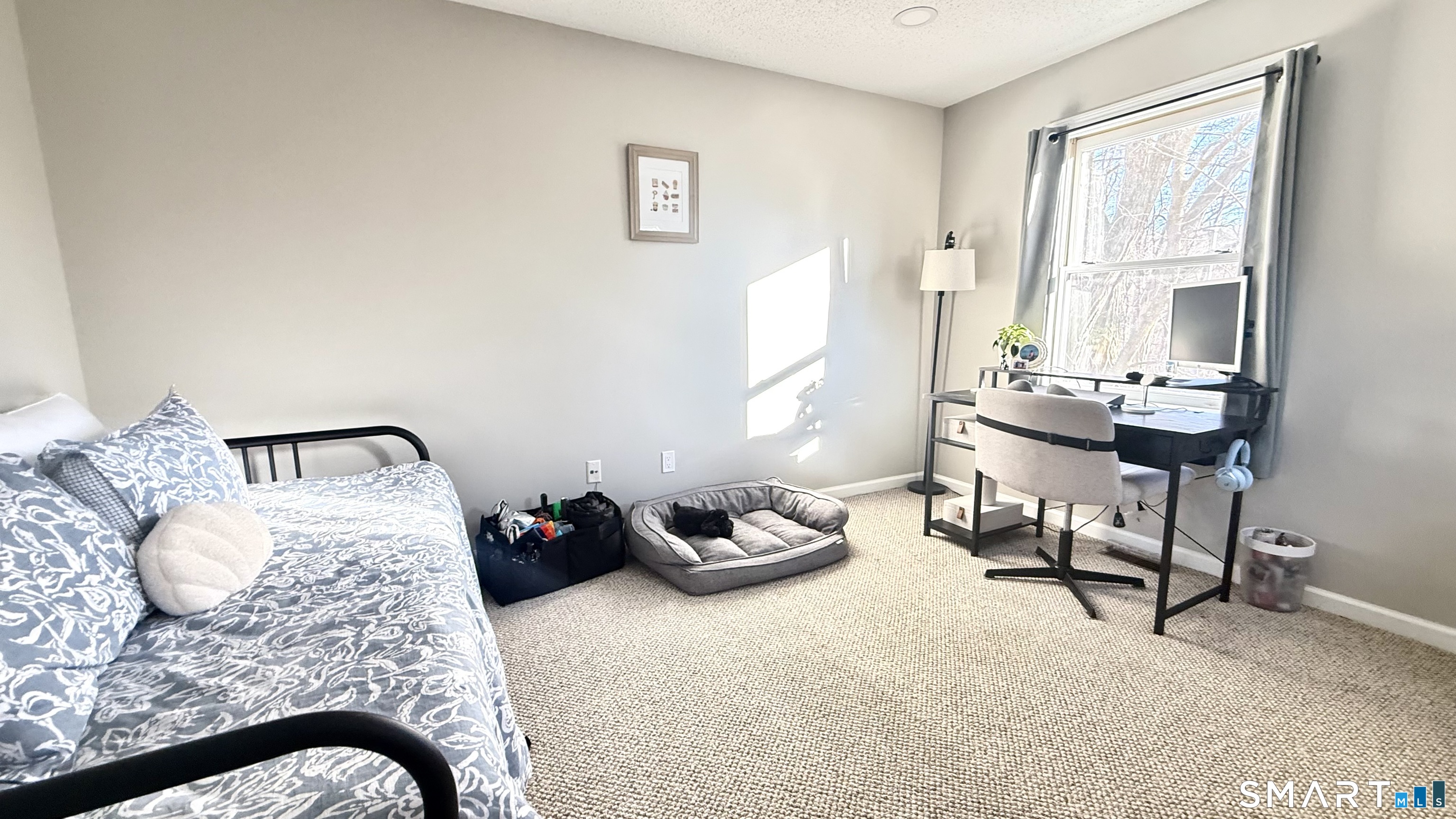 16 Maple Street, Unit 3 Vernon, CT 06066 - Photo 7 of 13 a bedroom with a bed and a chair