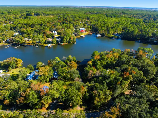 an aerial view of a houses with a lake view