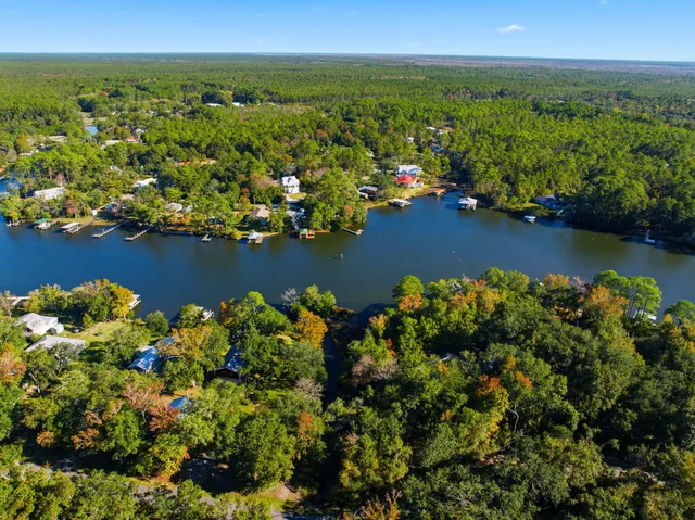 an aerial view of a houses with ocean view