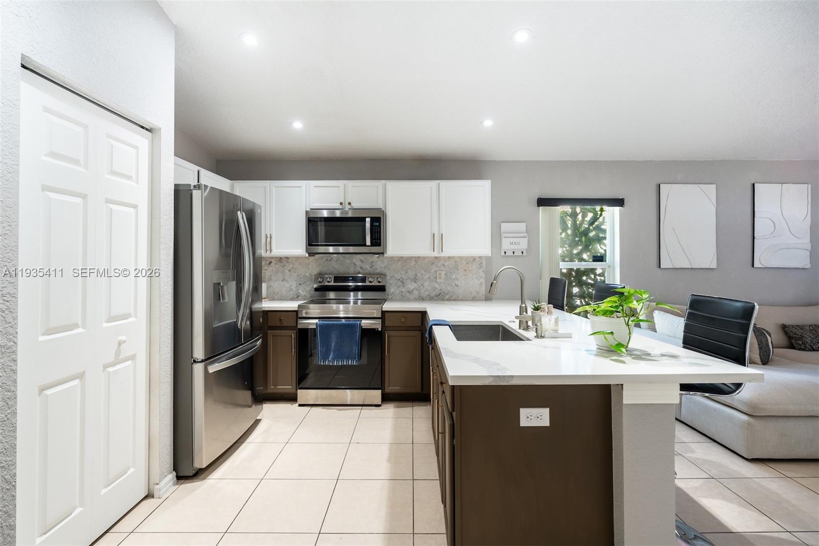 4521 Southwest 124th Terrace Miramar, FL 33027 - Photo 11 of 47 a kitchen with a refrigerator sink and stove