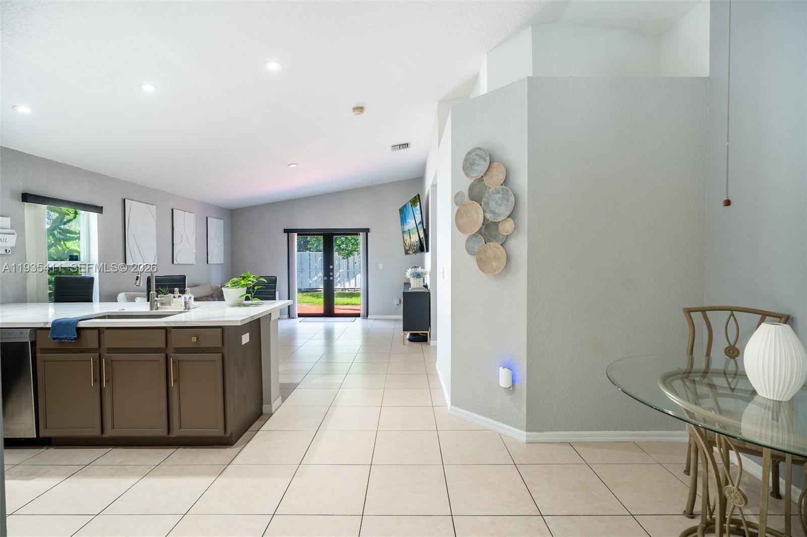 4521 Southwest 124th Terrace Miramar, FL 33027 - Photo 12 of 47 a large white kitchen with a window and refrigerator