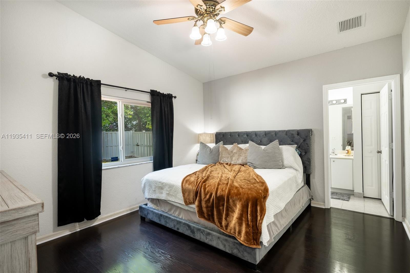 4521 Southwest 124th Terrace Miramar, FL 33027 - Photo 18 of 47 a bedroom with a bed table and two window