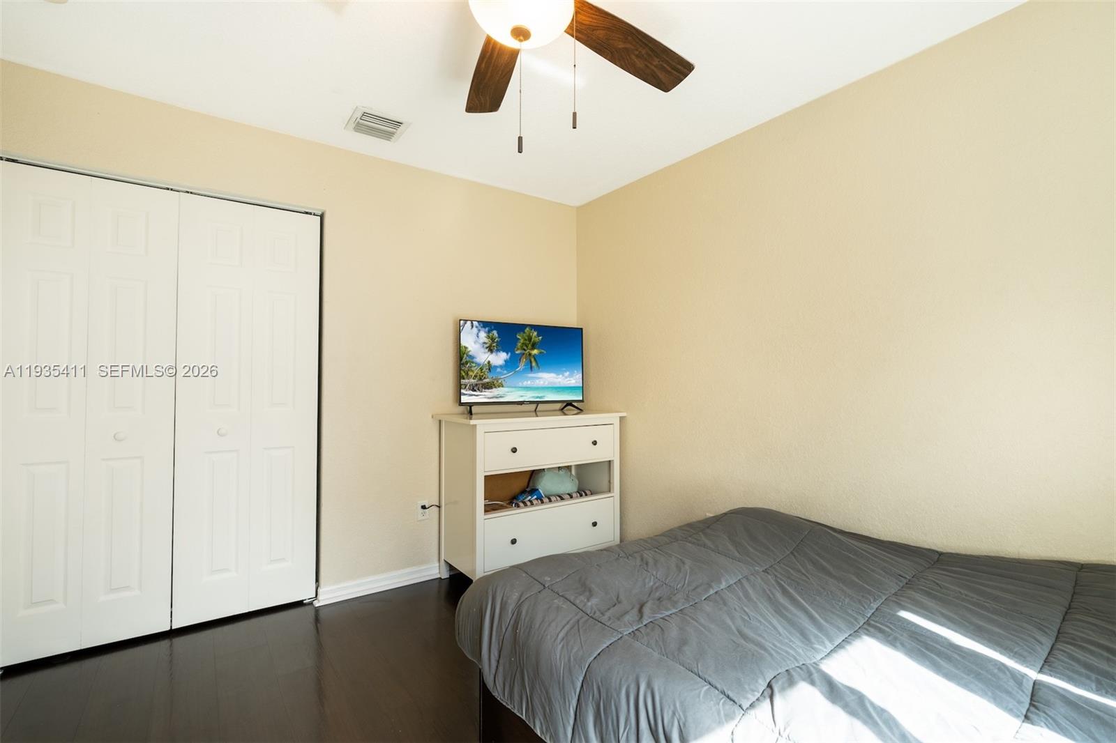 4521 Southwest 124th Terrace Miramar, FL 33027 - Photo 22 of 47 a bedroom with a bed and a ceiling fan