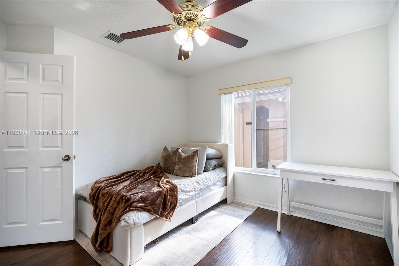 4521 Southwest 124th Terrace Miramar, FL 33027 - Photo 23 of 47 a bedroom with a bed and a chandelier