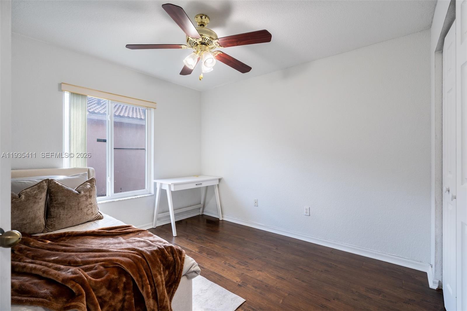 4521 Southwest 124th Terrace Miramar, FL 33027 - Photo 24 of 47 a bedroom with a bed and a chandelier