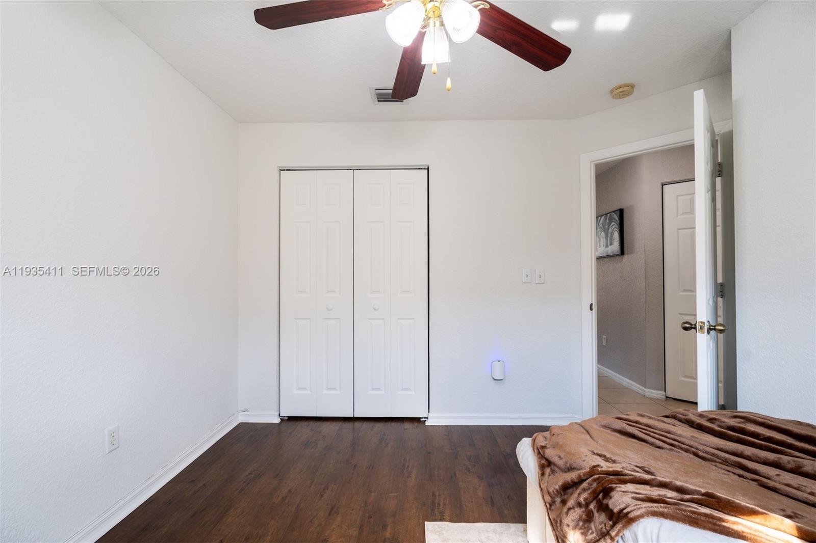 4521 Southwest 124th Terrace Miramar, FL 33027 - Photo 25 of 47 a bedroom with a bed and wooden floor