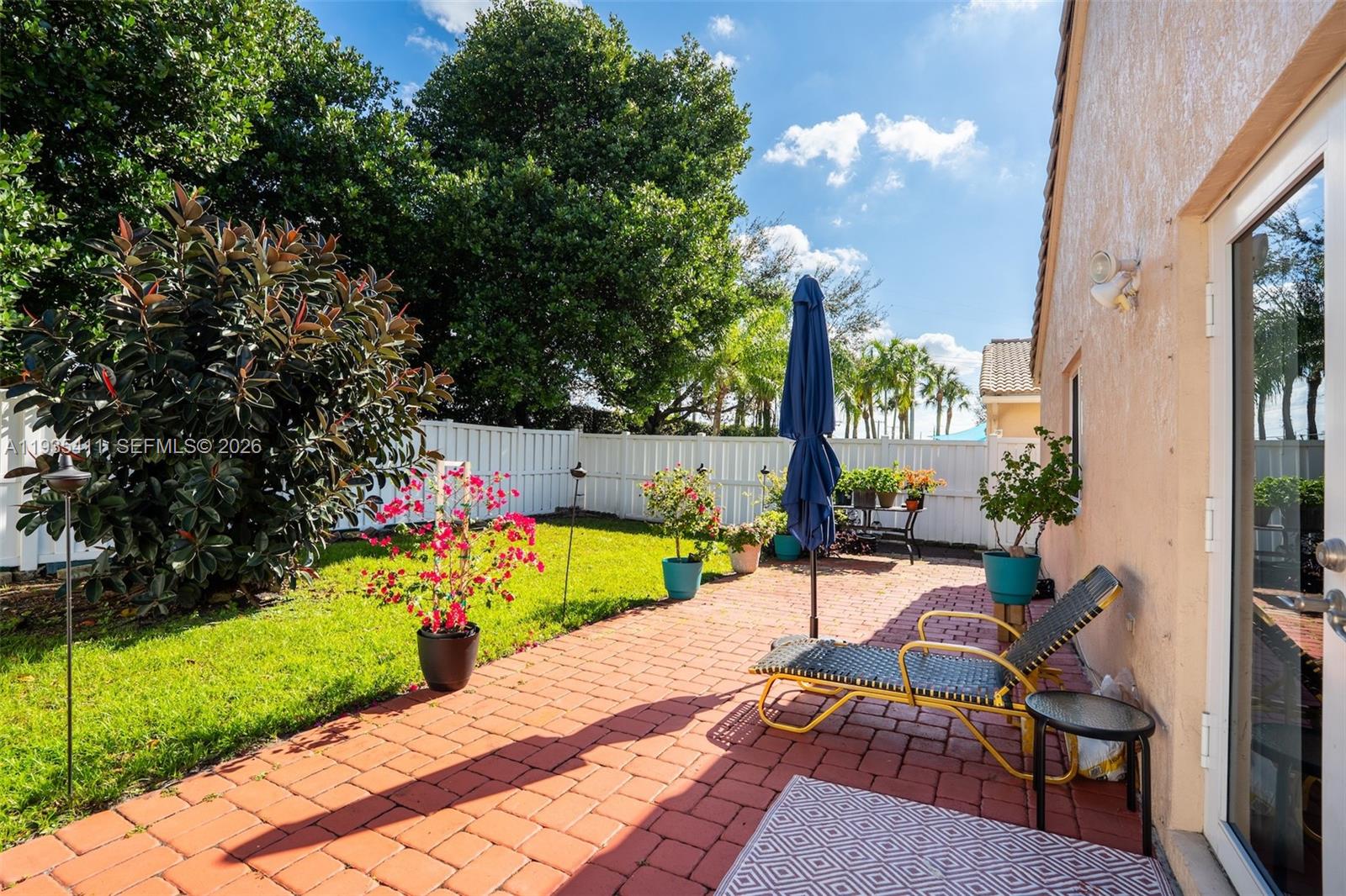 4521 Southwest 124th Terrace Miramar, FL 33027 - Photo 29 of 47 a view of a chair and tables in the patio