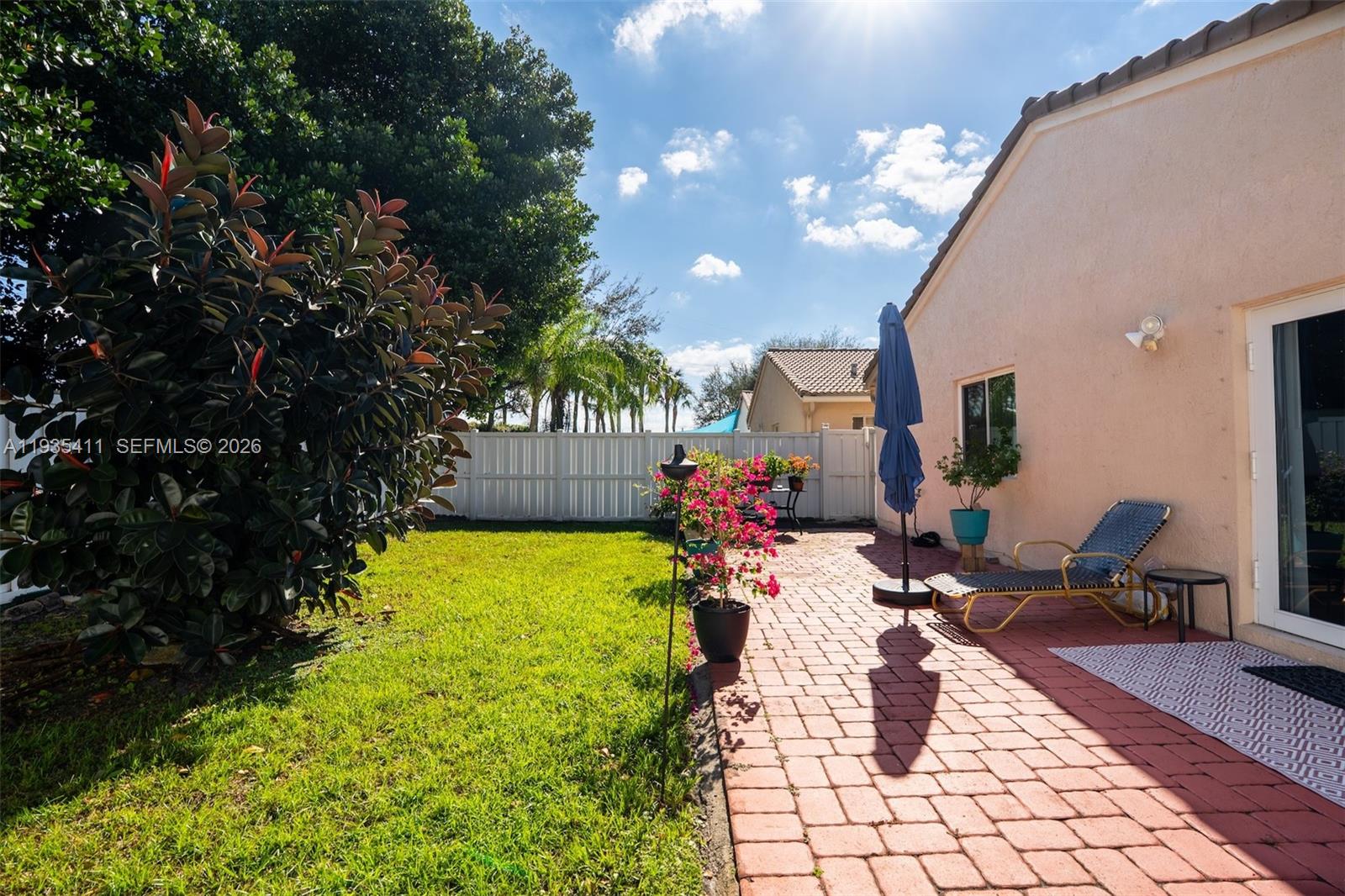 4521 Southwest 124th Terrace Miramar, FL 33027 - Photo 30 of 47 a backyard of a house with yard and outdoor seating