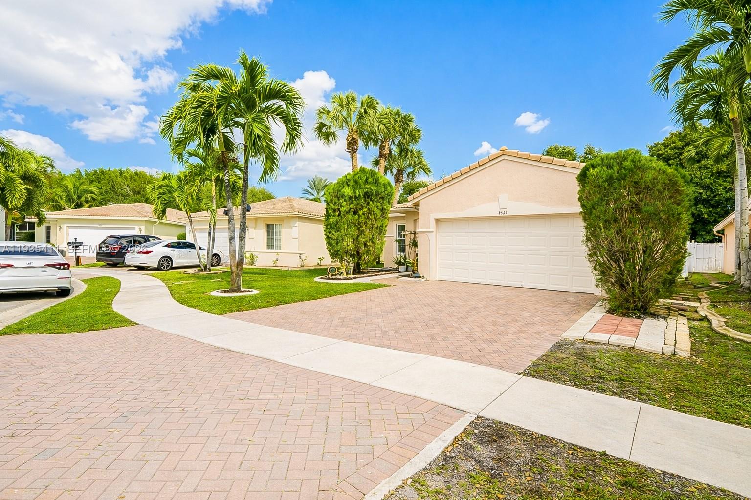 4521 Southwest 124th Terrace Miramar, FL 33027 - Photo 3 of 47 a view of yellow house with a yard and plants