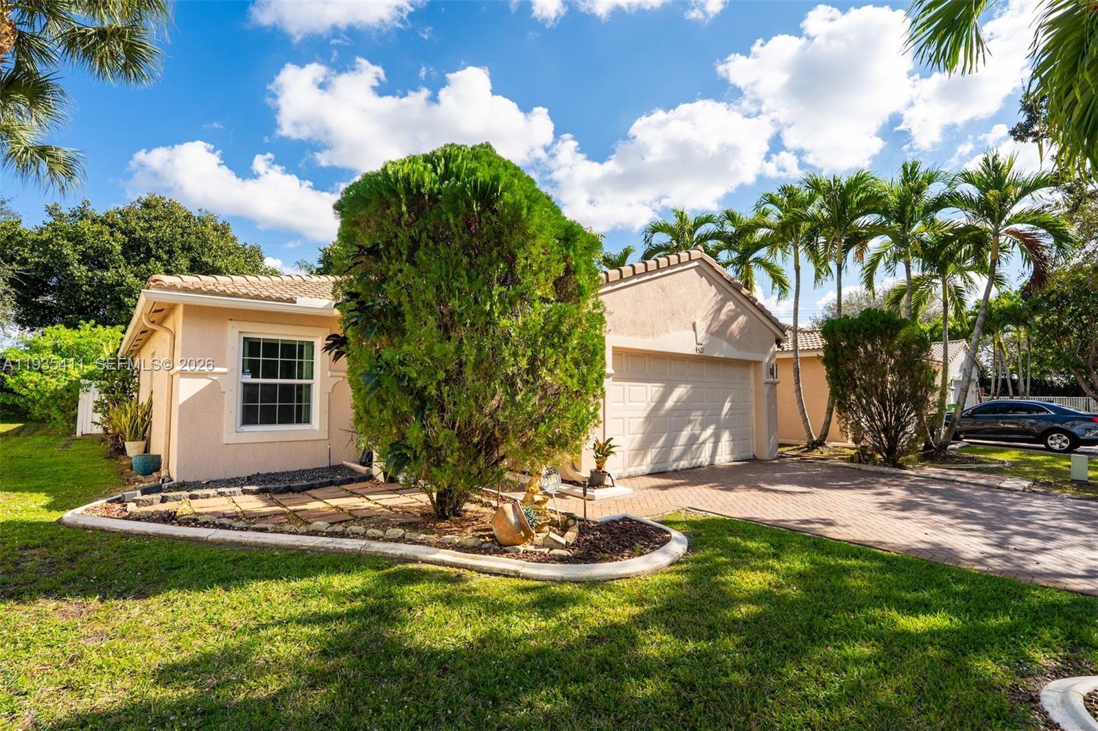 4521 Southwest 124th Terrace Miramar, FL 33027 - Photo 34 of 47 a view of a backyard with a barn plants and large tree