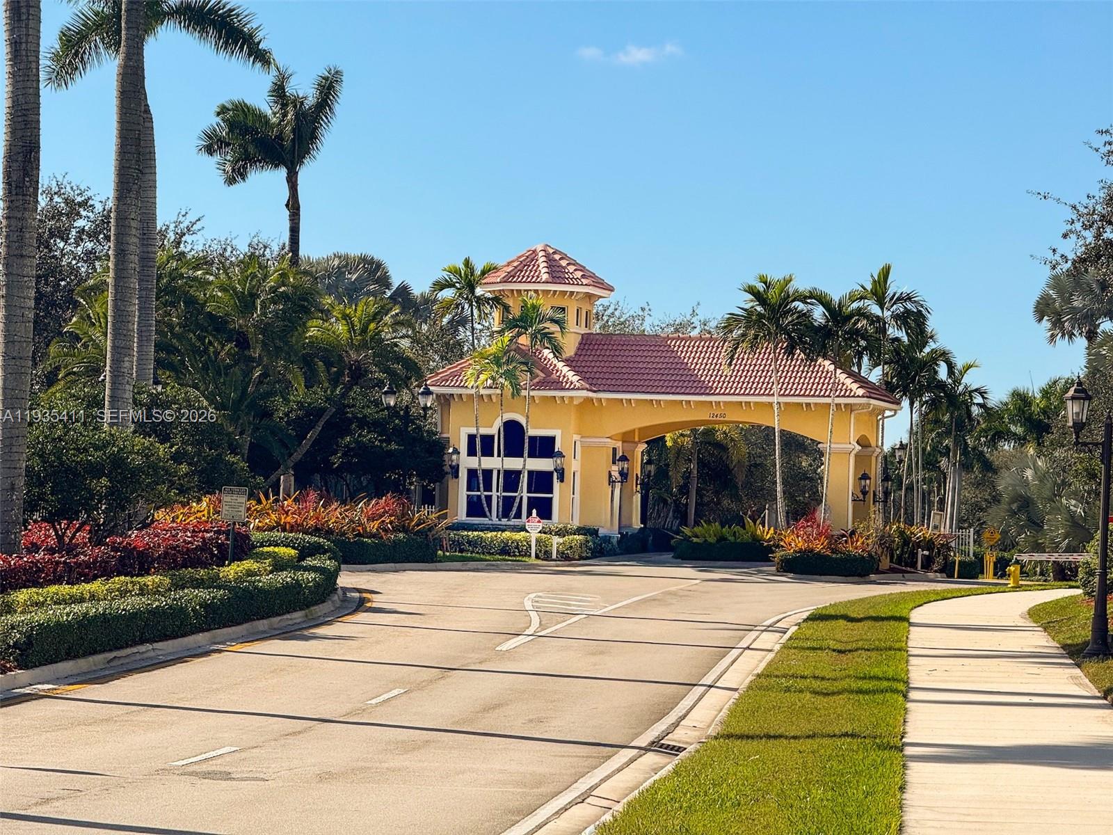 4521 Southwest 124th Terrace Miramar, FL 33027 - Photo 35 of 47 a front view of a building with lots of trees and plants