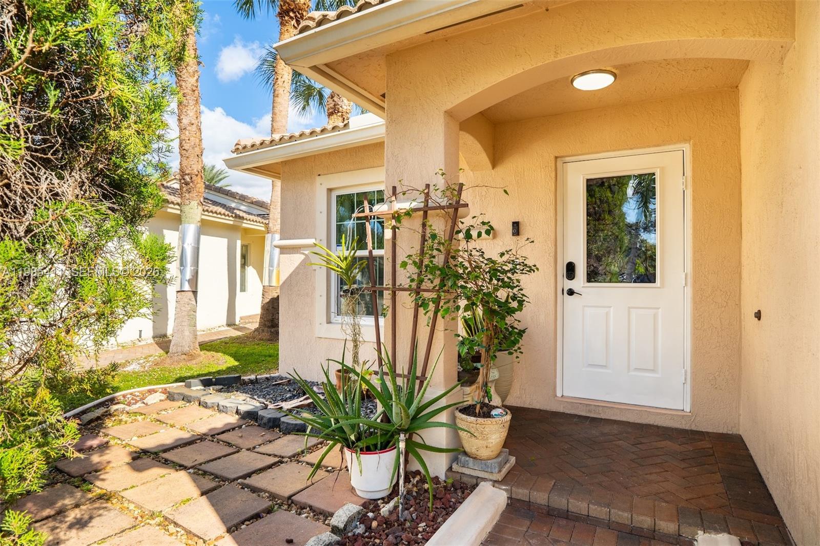 4521 Southwest 124th Terrace Miramar, FL 33027 - Photo 4 of 47 a potted plant sitting in front of a house