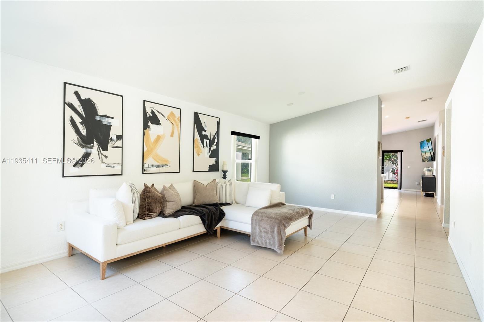 4521 Southwest 124th Terrace Miramar, FL 33027 - Photo 5 of 47 a spacious bedroom with a bed and lamp