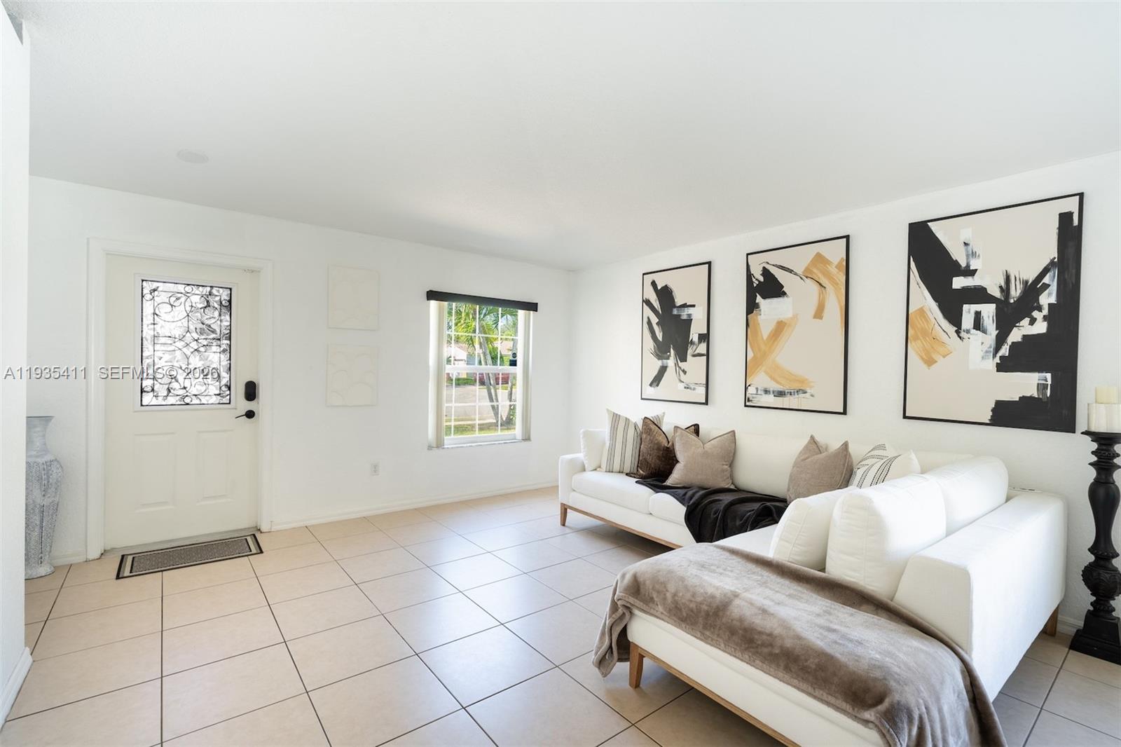 4521 Southwest 124th Terrace Miramar, FL 33027 - Photo 6 of 47 a living room with couches and painting on the wall