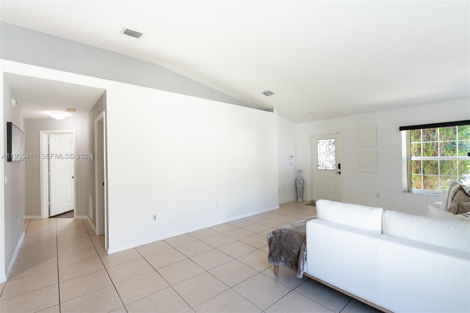4521 Southwest 124th Terrace Miramar, FL 33027 - Photo 7 of 47 a living room with furniture and a window