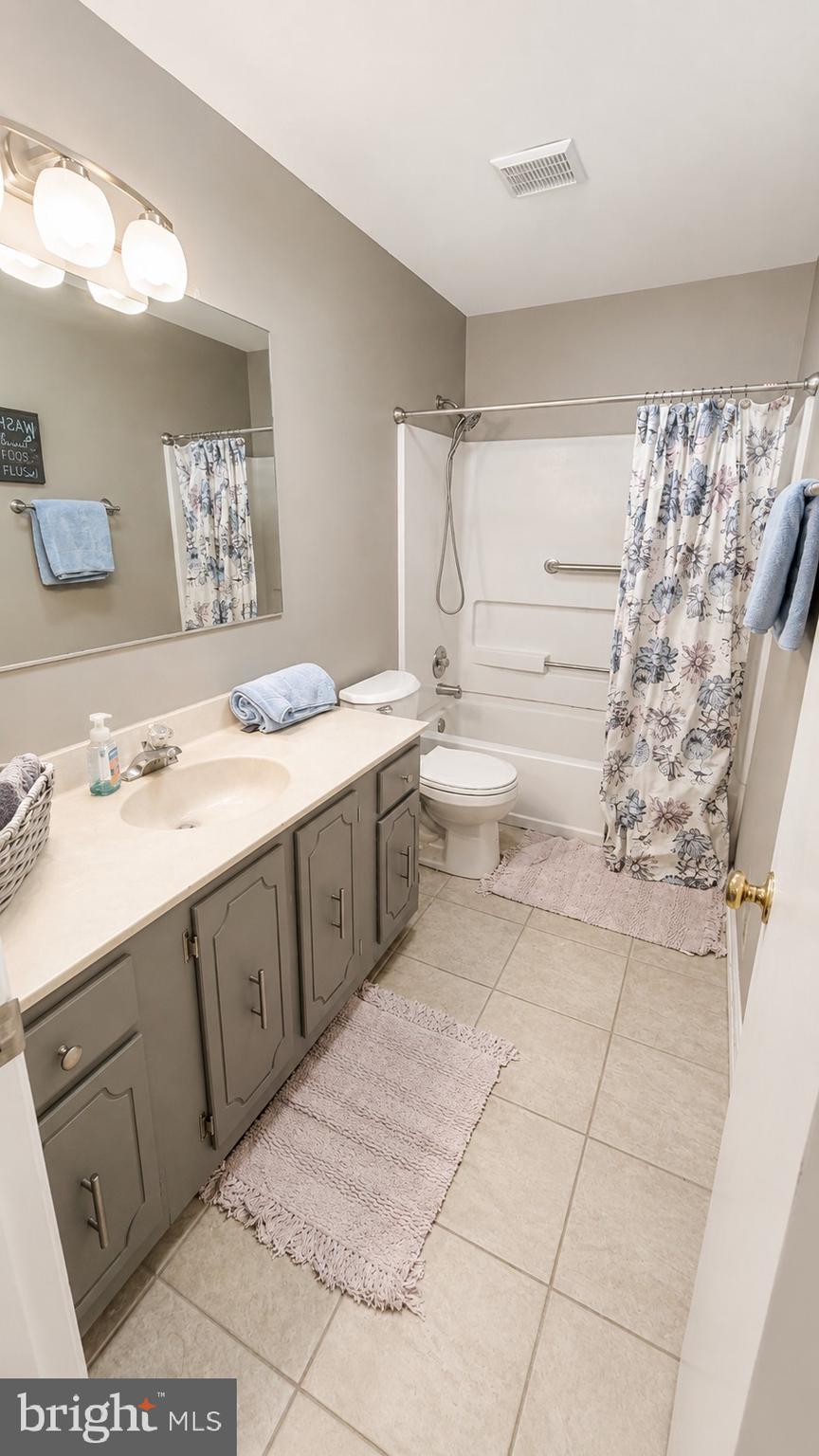 15370 Inlet Place Dumfries, VA 22025 - Photo 20 of 30 a bathroom with a sink a toilet and shower