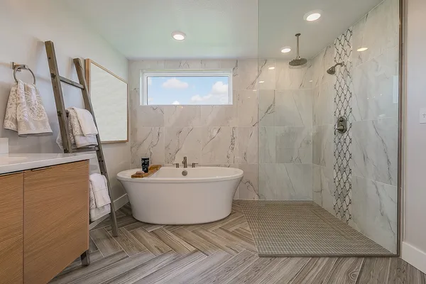 a bathroom with a bathtub a shower and a sink