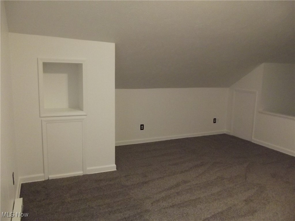 3904 Snow Road Cleveland, OH 44134 - Photo 28 of 50 Additional living space with dark carpet and vaulted ceiling