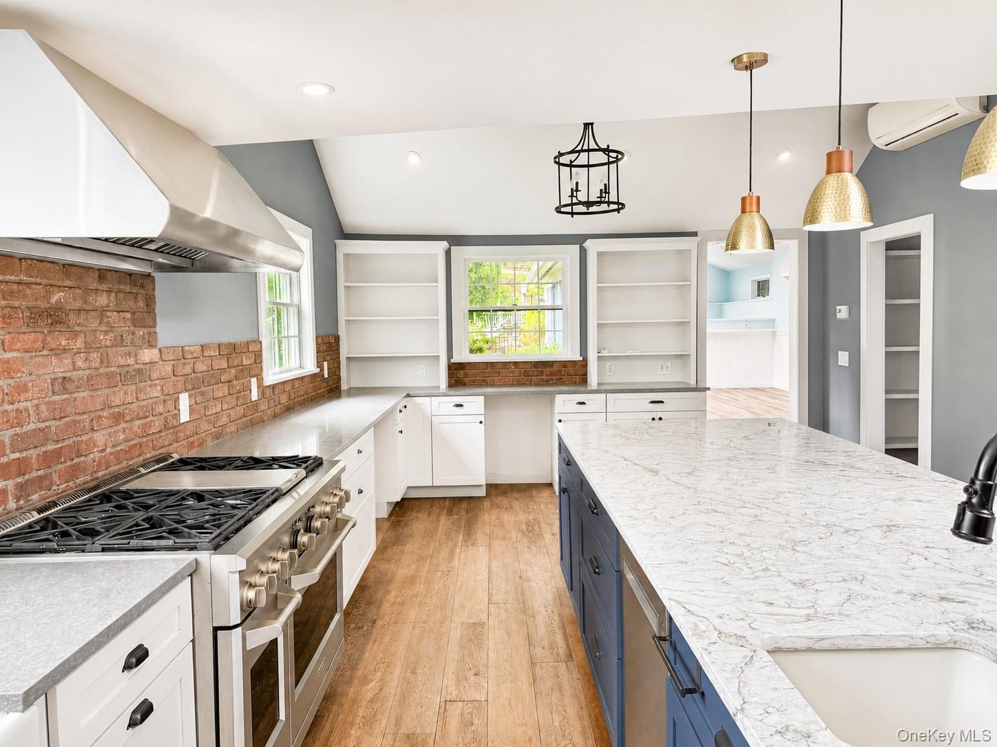 82 Shingle House Road Millwood, NY 10546 - Photo 3 of 6 Chef's kitchen designed for both everyday living and entertaining, featuring a professional-grade dual-oven gas range with commercial-style hood, oversized waterfall island, quartz countertops, custom cabinetry, open shelving,