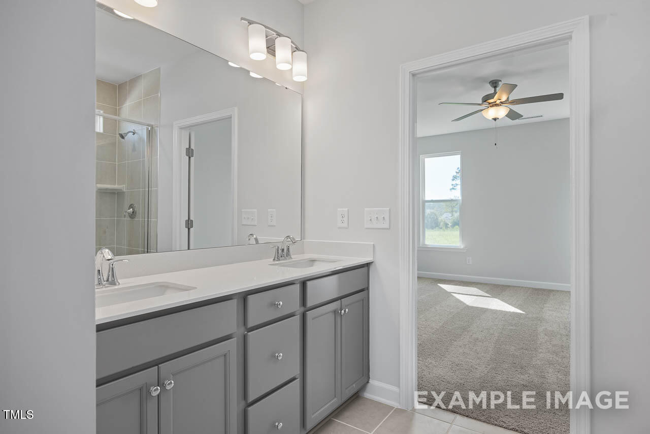 202 Golden Leaf Farms Road Angier, NC 27501 - Photo 17 of 38 a en suite bathroom with a granite countertop sink and a mirror