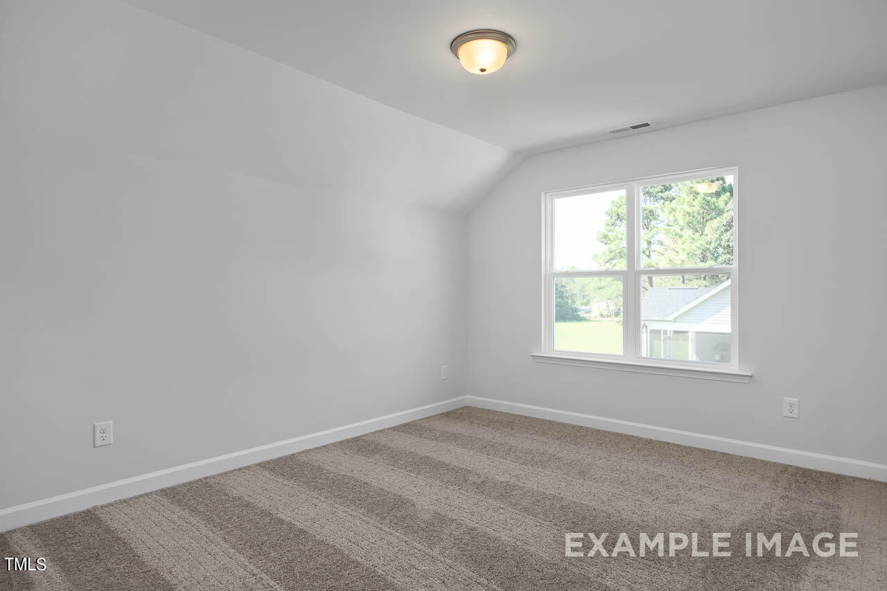 202 Golden Leaf Farms Road Angier, NC 27501 - Photo 21 of 38 an empty room with a window