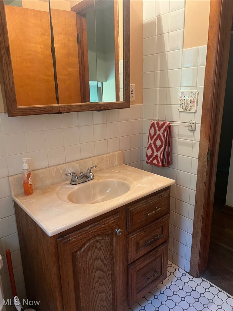 10504 Mulberry Road Chardon, OH 44024 - Photo 20 of 23 Bathroom featuring tile walls, vanity, and tile flooring