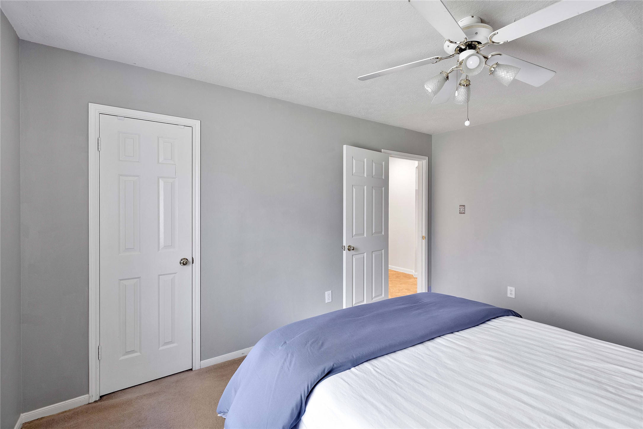 1707 Moston Drive Spring, TX 77386 - Photo 31 of 41 a bedroom with a bed and a chandelier fan